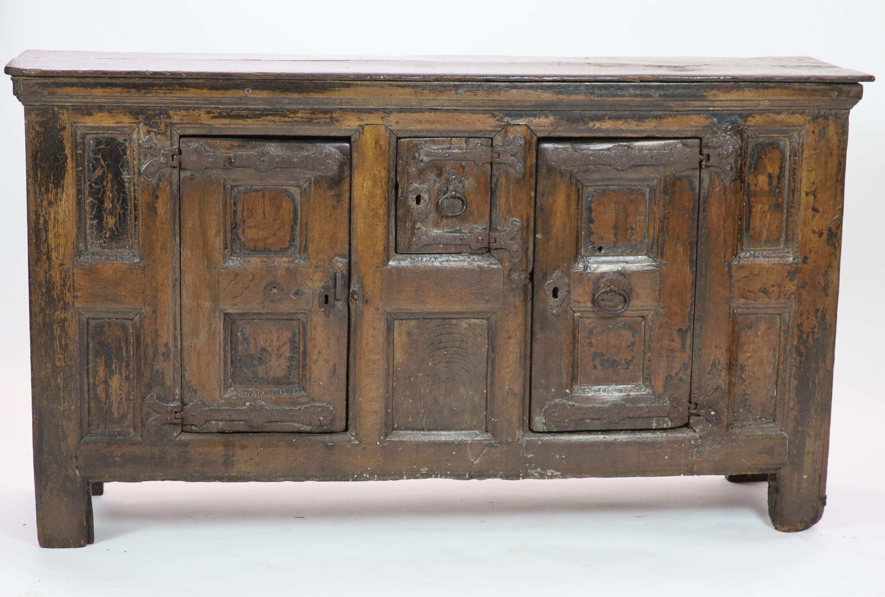 A late 16th/early 17th century German oak side cupboard H 104cm. W 185cm. D 49cm.